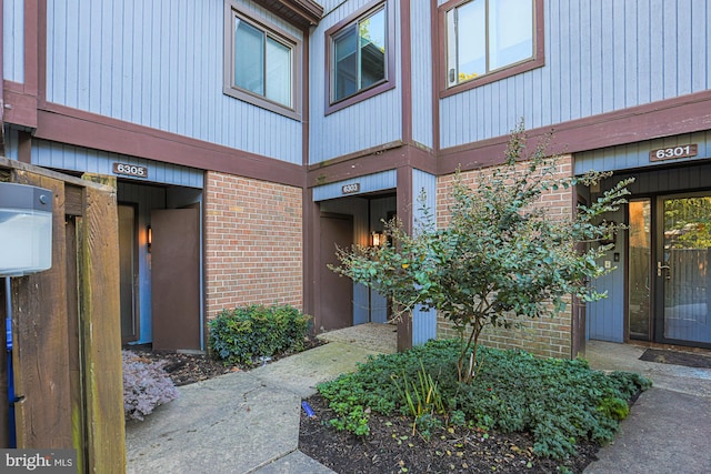 property entrance with brick siding