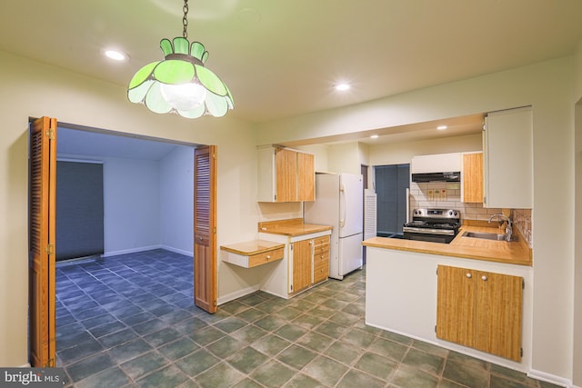 kitchen featuring light countertops, backsplash, a sink, stainless steel range with electric stovetop, and extractor fan