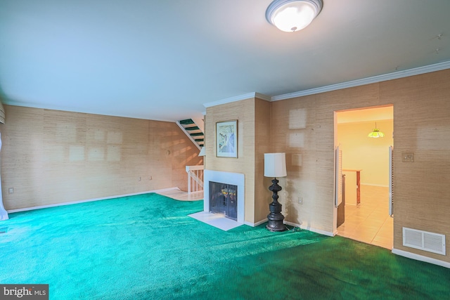 unfurnished living room with ornamental molding, a fireplace with flush hearth, visible vents, and wallpapered walls