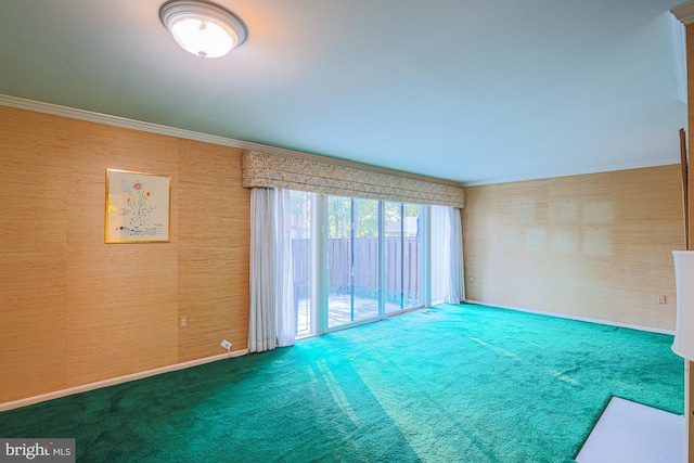 carpeted spare room featuring ornamental molding, baseboards, and wallpapered walls