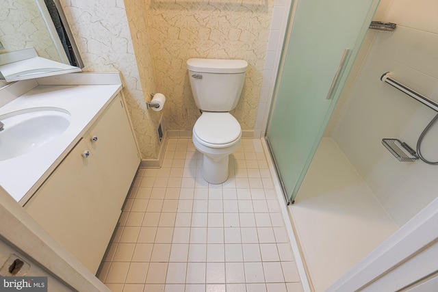 full bathroom with vanity, a shower stall, toilet, and tile patterned floors