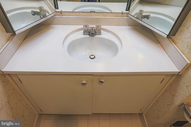 bathroom featuring tile patterned flooring and vanity