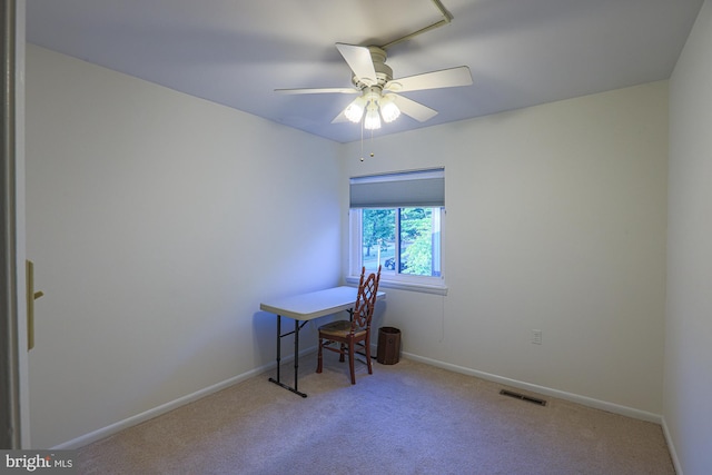 carpeted home office featuring baseboards, visible vents, and ceiling fan