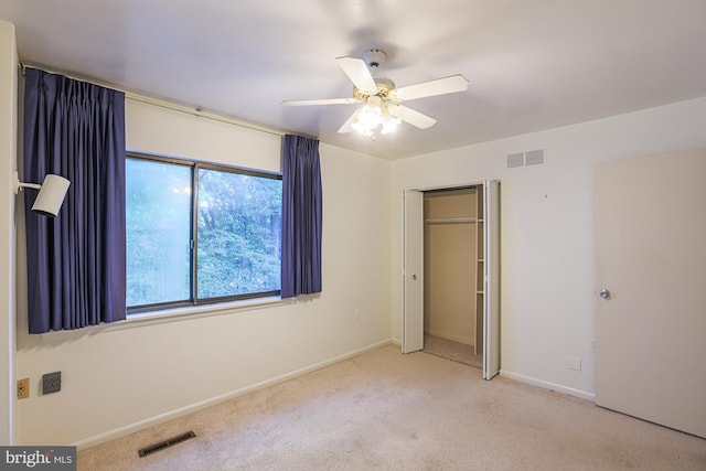 unfurnished bedroom featuring carpet floors, baseboards, visible vents, and a closet