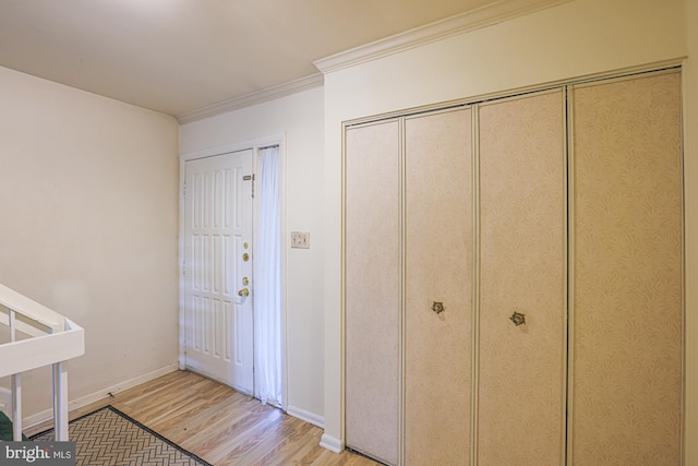 entrance foyer with crown molding, light wood-style flooring, and baseboards