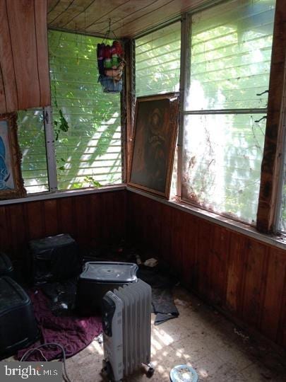 sunroom featuring radiator heating unit