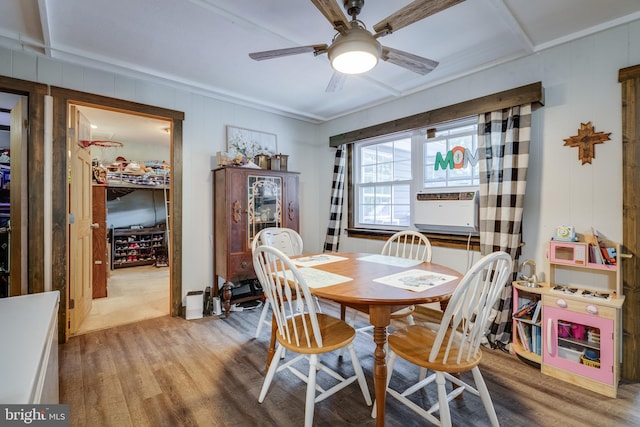 dining space with wood-type flooring, ceiling fan, and cooling unit