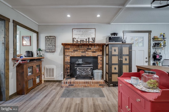 living room featuring hardwood / wood-style flooring and a brick fireplace