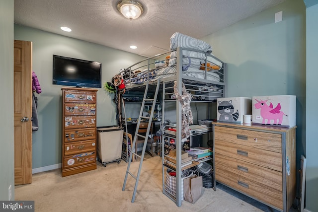 bedroom featuring a textured ceiling and light colored carpet