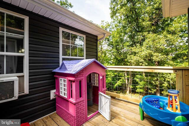 wooden terrace featuring cooling unit