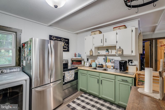 kitchen featuring white cabinetry, green cabinets, sink, washer / dryer, and appliances with stainless steel finishes