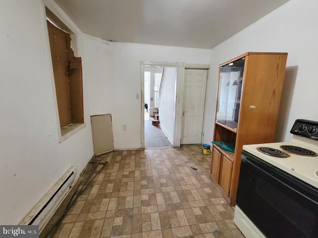 kitchen featuring light tile patterned flooring, electric stove, and a baseboard heating unit