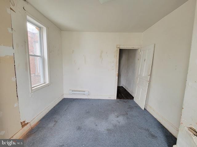 carpeted empty room featuring a wealth of natural light