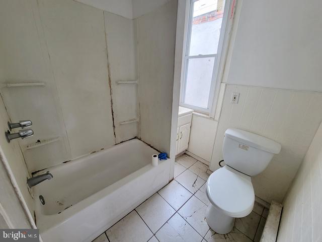 full bathroom with vanity, toilet, tile patterned flooring, and plenty of natural light