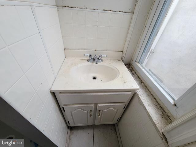 bathroom with tile walls and vanity