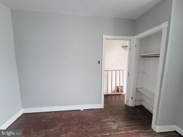 unfurnished bedroom with a closet and wood-type flooring