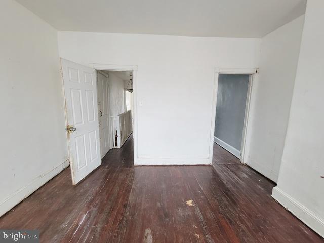 empty room with hardwood / wood-style flooring