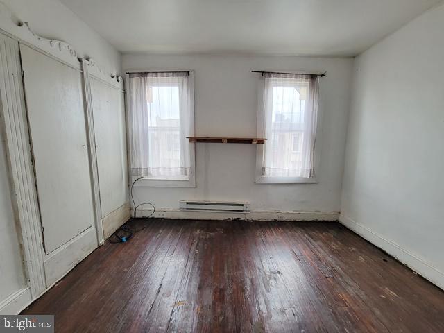 interior space featuring a baseboard radiator and hardwood / wood-style floors