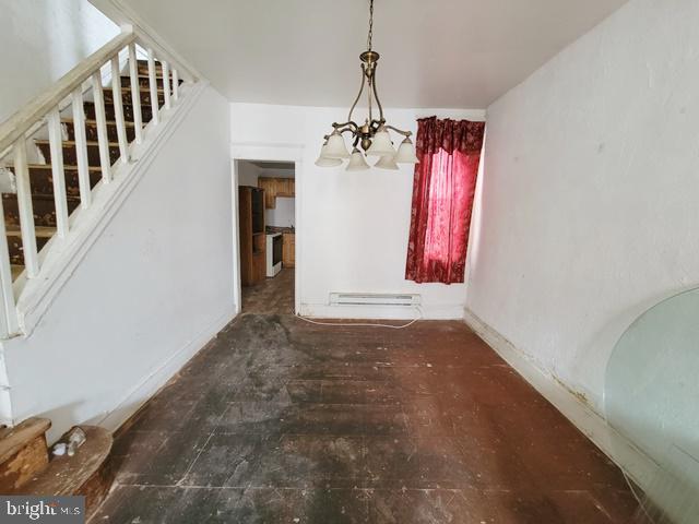 dining room with hardwood / wood-style flooring, a notable chandelier, and baseboard heating