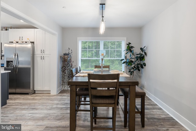 dining area with hardwood / wood-style floors