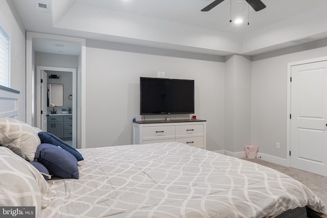 carpeted bedroom featuring ensuite bath and ceiling fan