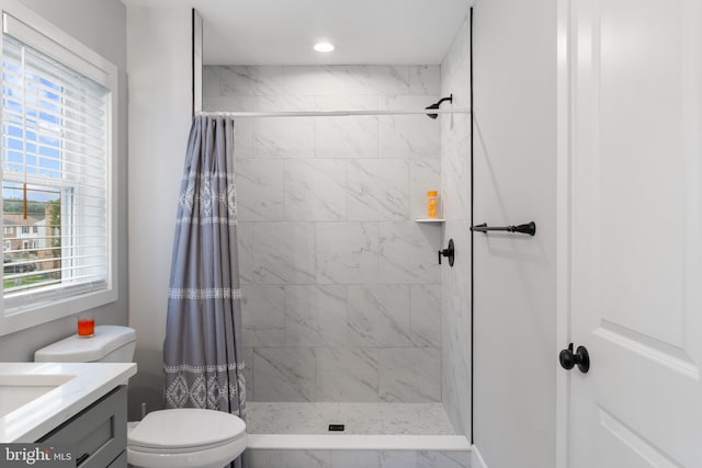 bathroom featuring vanity, a shower with shower curtain, and toilet