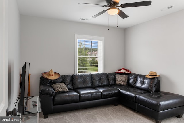 carpeted living room with ceiling fan