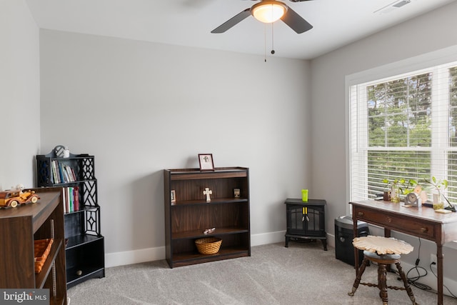 home office with ceiling fan and light colored carpet