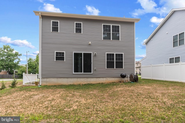 rear view of property with a lawn