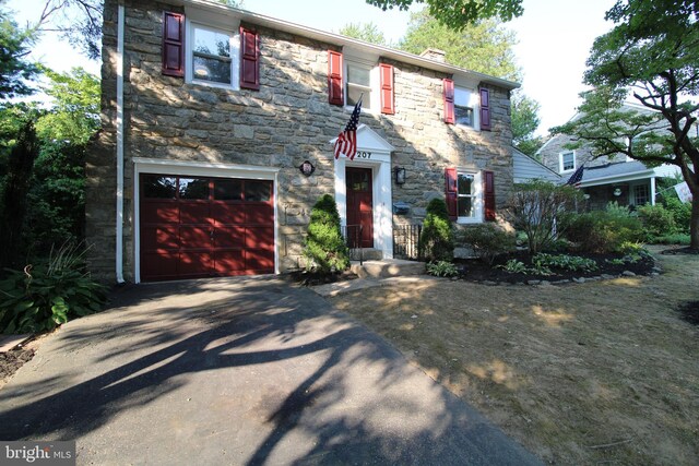 colonial inspired home with a garage