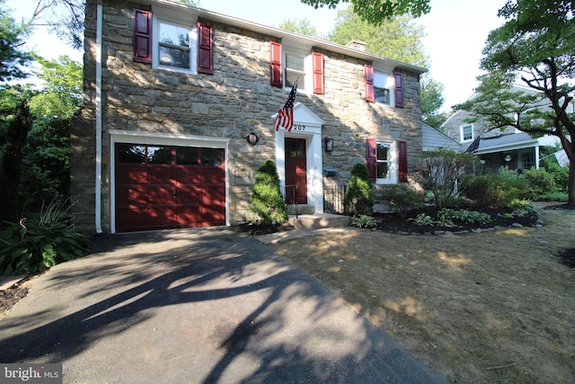 colonial inspired home featuring a garage