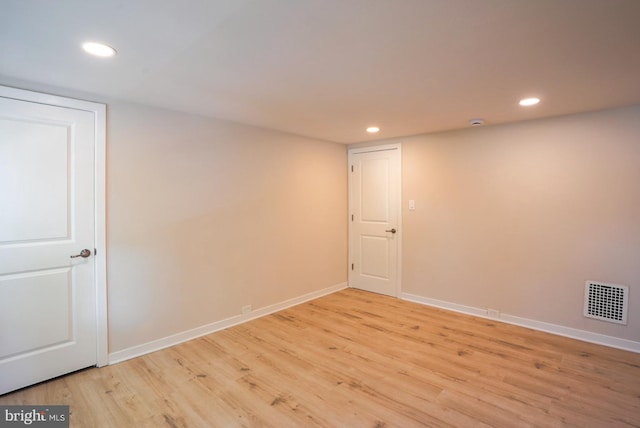 unfurnished room with light wood-type flooring