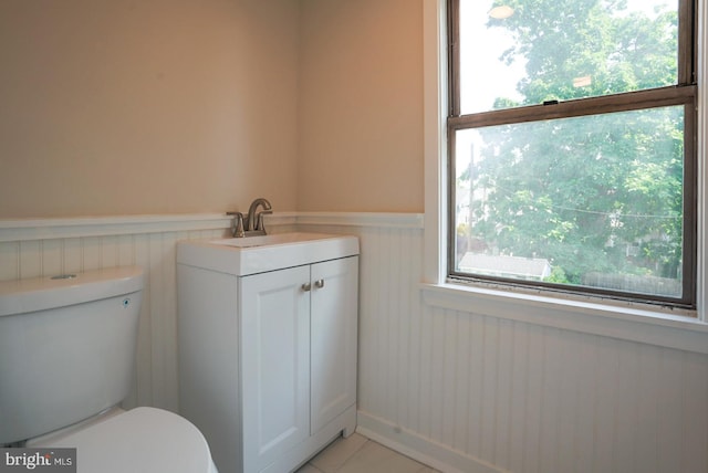 bathroom featuring vanity, tile patterned flooring, and toilet