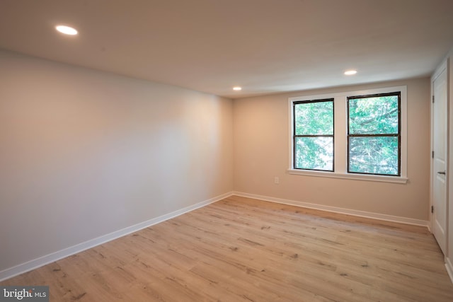 unfurnished room with light hardwood / wood-style flooring