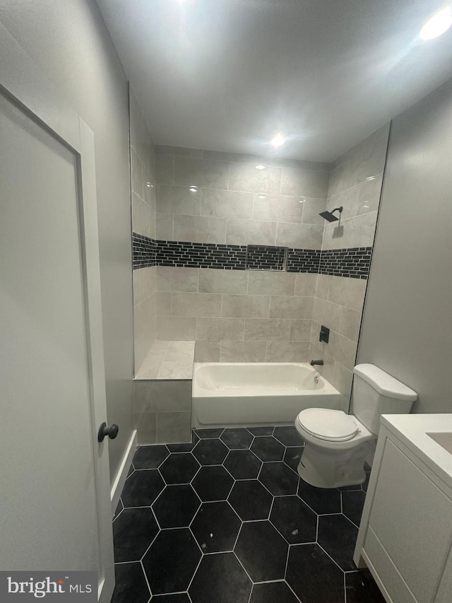 bathroom with tile patterned floors, toilet, and vanity