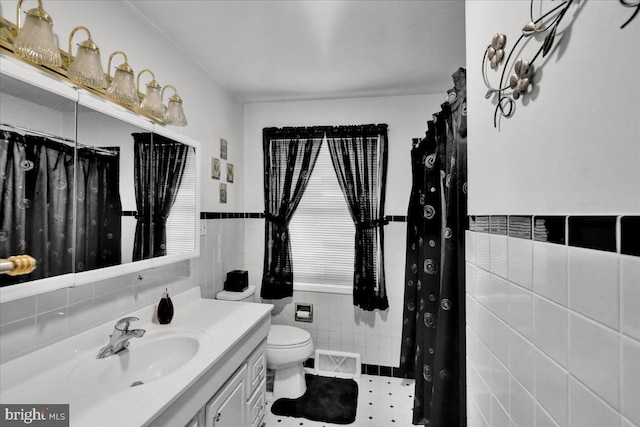 bathroom featuring tile walls, tile patterned floors, toilet, and vanity