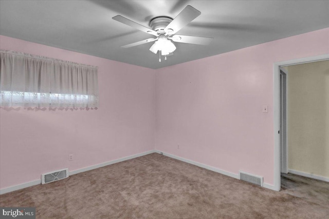 carpeted spare room with ceiling fan