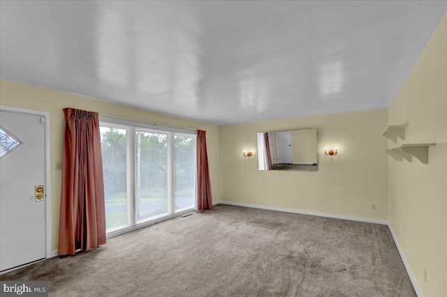 unfurnished living room with light colored carpet