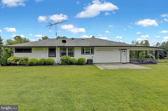 rear view of property featuring central air condition unit, a patio, and a yard