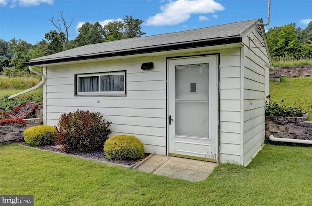 view of outbuilding featuring a lawn