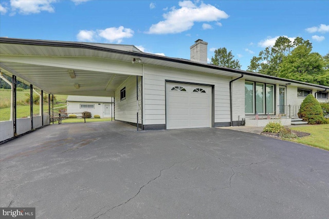 exterior space featuring a garage and a carport