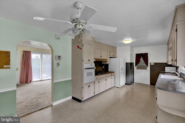 kitchen featuring white appliances, sink, and ceiling fan