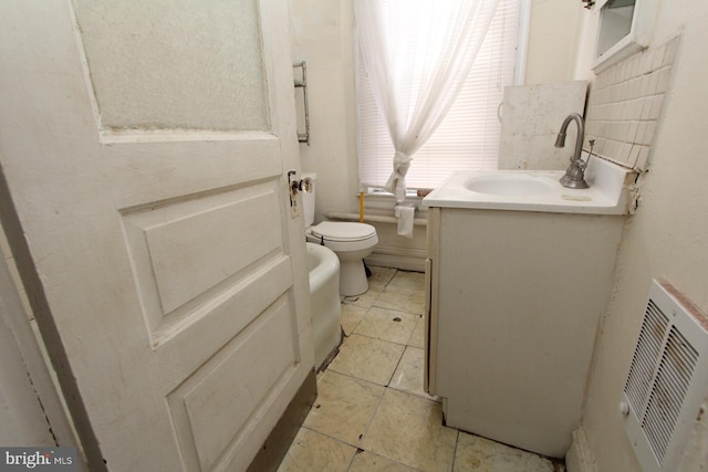 bathroom featuring tile patterned floors, toilet, and vanity