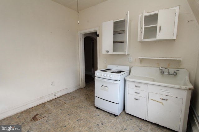 kitchen with electric stove, sink, light tile patterned flooring, and white cabinetry