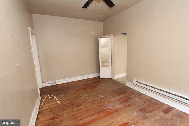 empty room featuring hardwood / wood-style floors, a baseboard radiator, and ceiling fan