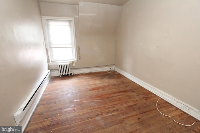 empty room featuring dark wood-type flooring, radiator heating unit, and a baseboard radiator