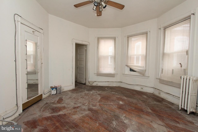 unfurnished bedroom with ceiling fan and radiator