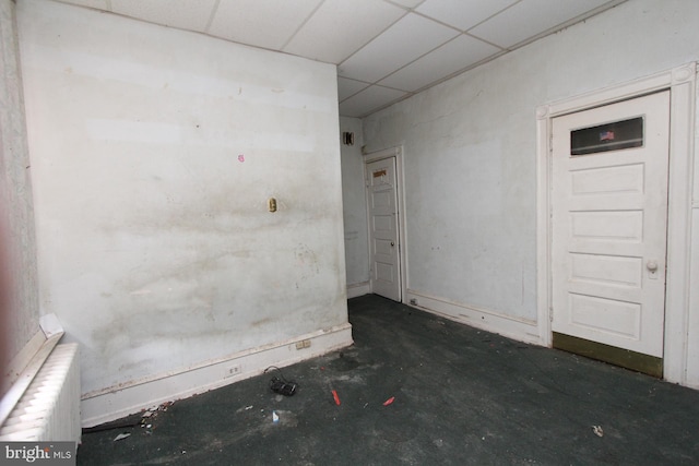 spare room with a paneled ceiling