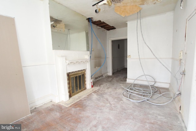 unfurnished living room featuring a fireplace and concrete flooring