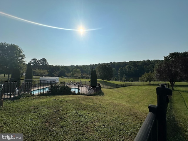 view of yard with a fenced in pool